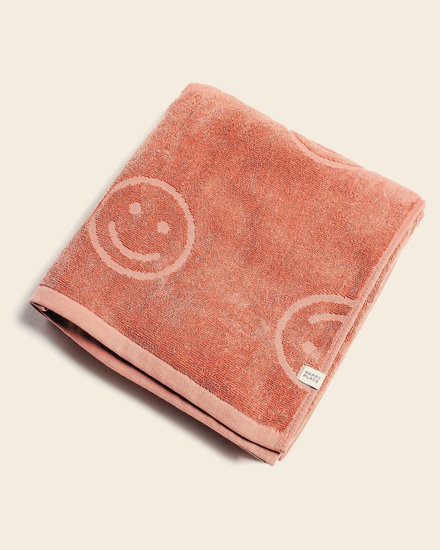 folded terra cotta embossed smiley towel