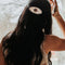 model wearing round pony barrette with tortoise quilt inspired six point star and black trim