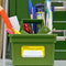 green small storage caddy with various stationery items inside