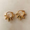 up close of gold spike huggie hoops