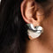 model wearing silver oversized puffy heart shaped stud earrings