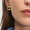 model wearing gold dome huggie hoops