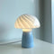lit blue mushroom glass table lamp