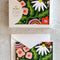 packaged card set of 12 with dark green ground and colorful abstract garden design