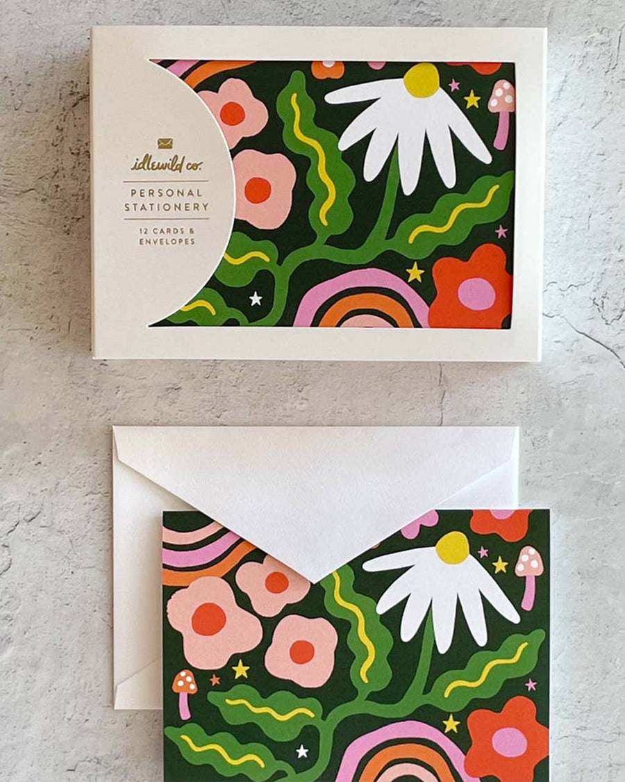 packaged card set of 12 with dark green ground and colorful abstract garden design