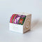 packaged set of three abstract floral washi tape rolls: pink and white floral, colorful wavy squiggles, and pink and red abstract floral