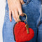 model holding red beaded heart coin purse with gold hardware