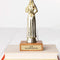 'in my no f's given era' trophy on a stack of books