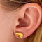 model wearing dainty deli sandwich shaped stud enamel earrings