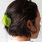model wearing lime shaped hair claw