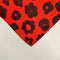 red napkin with with black abstract flower pattern
