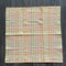 cream tea towel with colorful thin plaid print