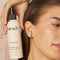 model holding Moisturizing Argan Milk Leave-in Conditioner