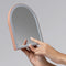 model holding terracotta LED arch desk mirror in their hand
