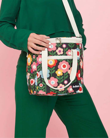 model wearing mini cooler bag with colorful mod inspired floral print