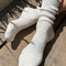 model wearing white textured fluffy socks