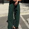 model wearing pine green arc pants with side pockets
