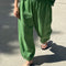 model wearing asparagus balloon pants