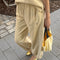 side view of model wearing butter yellow balloon pants with matching top