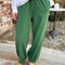 model wearing cotton moss green balloon pants with side pockets