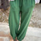 model wearing cotton moss green balloon pants with side pockets