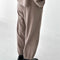 back view of model wearing mushroom brown balloon pants and matching top