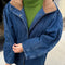 model wearing relaxed denim jacket with longer length and tan corduroy collar