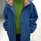 model wearing relaxed denim jacket with longer length and tan corduroy collar