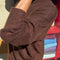 side view of model wearing dark brown mohair crew neck sweater