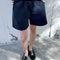 model wearing navy cotton shorts
