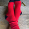 model wearing bright red socks with navy toes and heel