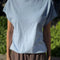 model wearing light blue cap sleeve tee