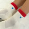 up close of model wearing white crew socks with red trim and light blue embroidered heart