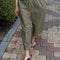 model wearing army green pants with workmen patches down the front and inner drawstring