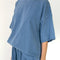 side view of model wearing cornflower oversized tee with oversized sleeves