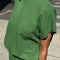 side view of model wearing asparagus tee with small side vents and muscle tee sleeves
