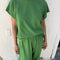 model wearing asparagus tee with small side vents and muscle tee sleeves