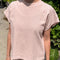 model wearing baby pink relaxed fit cotton tee with muscle type sleeves and side vents
