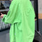 back view of model wearing oversized spring green button down top