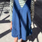 model wearing blue denim mini dress with green and white striped top
