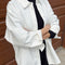 model wearing un-buttoned oversized cotton white button down top
