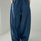 model wearing denim blue parachute cotton pants