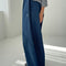 side view of model wearing denim blue parachute cotton pants