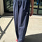 model wearing navy billowy parachute pants