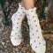 model wearing white ruffle socks with pink dainty flower print