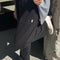 model wearing black cotton straight leg pants