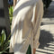 sideview of model wearing naturel long sleeve tee with deep side vents