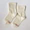 white socks with thin pale yellow stripes
