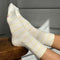 model wearing white socks with thin pale yellow stripes