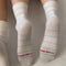 model wearing white socks with thin sky blue stripes